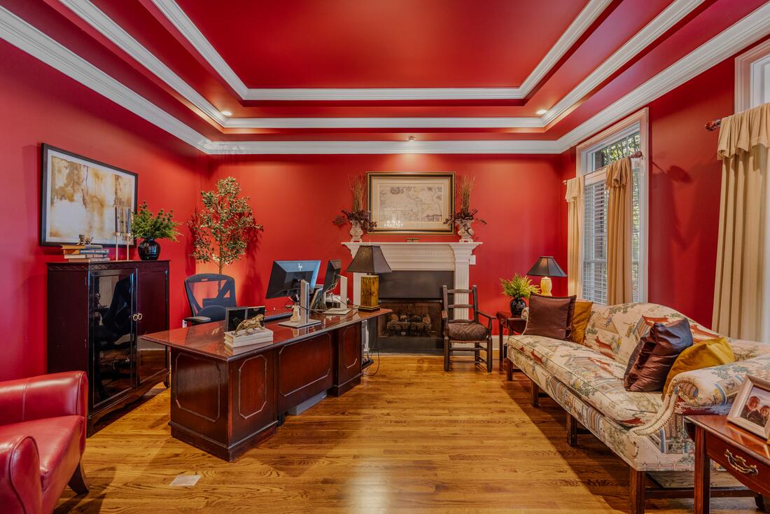 Study with tray ceiling and fireplace