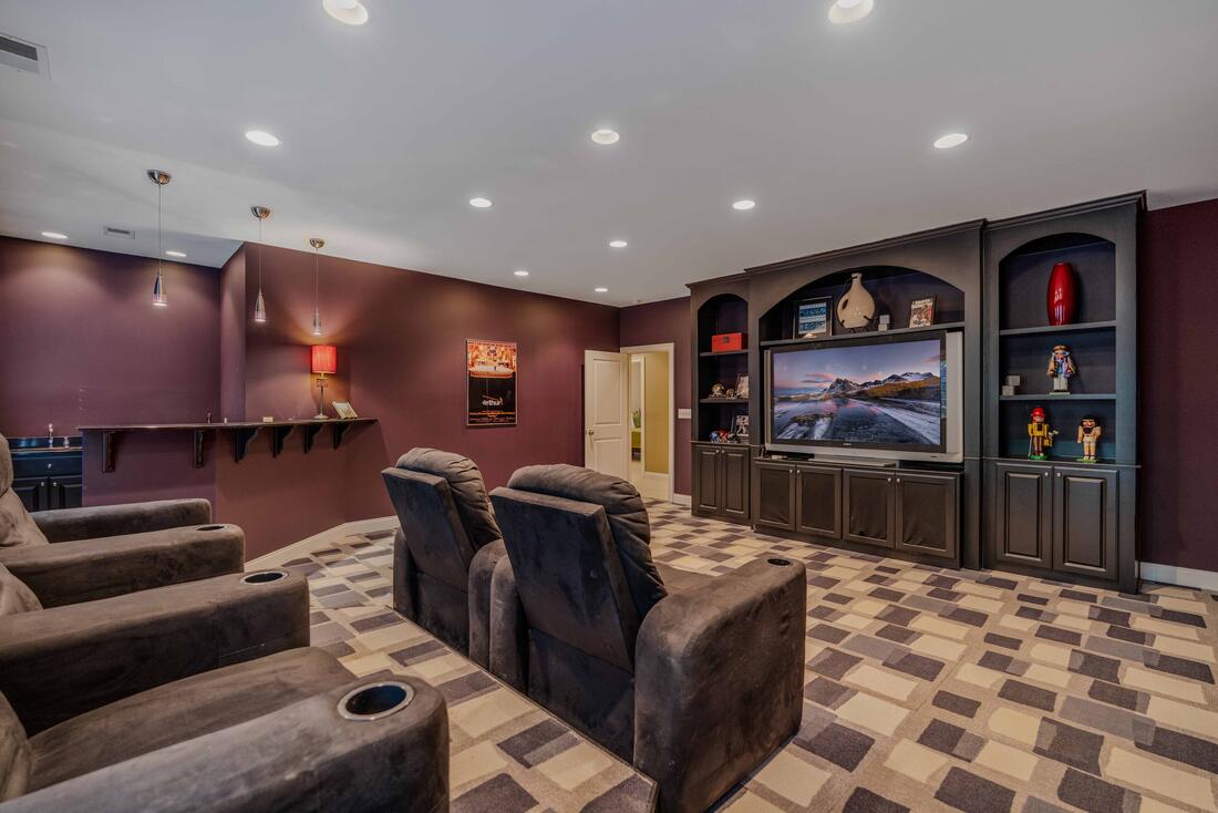 Media room with tiered theater seating